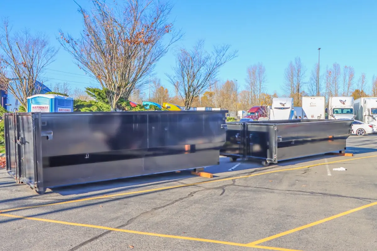 Professional dumpster rental service with roll-off container on residential driveway in Scaggsville